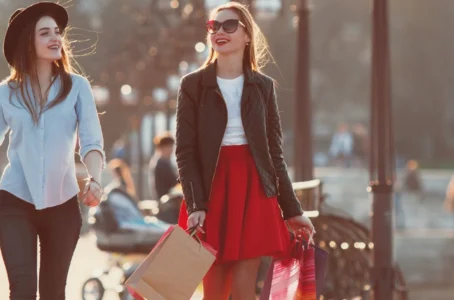 Two women walking on street with shopping bags